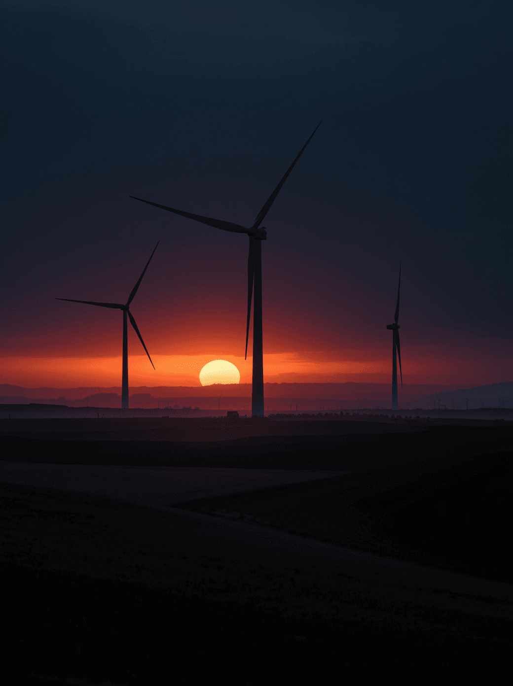 UK wind turbines at golden hour — the energy infrastructure OT Energy works across